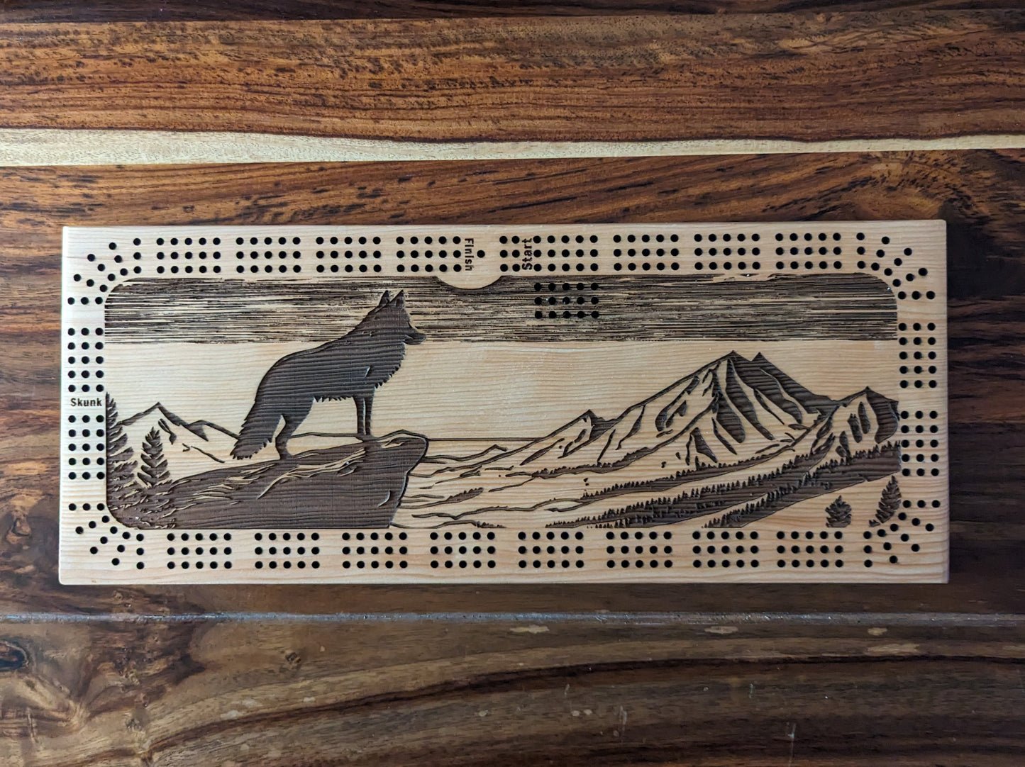 A wolf looking over a valley, 3 Track Cribbage Board - Laser engraved