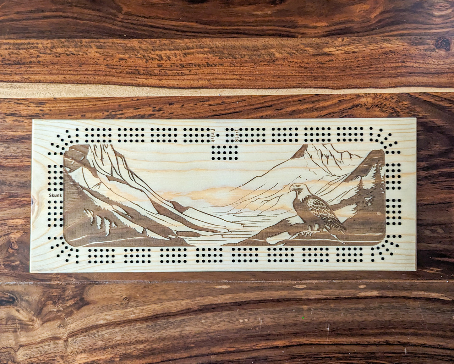 Bald Eagle on a branch looking over a valley, 3 Track Cribbage Board - Laser engraved