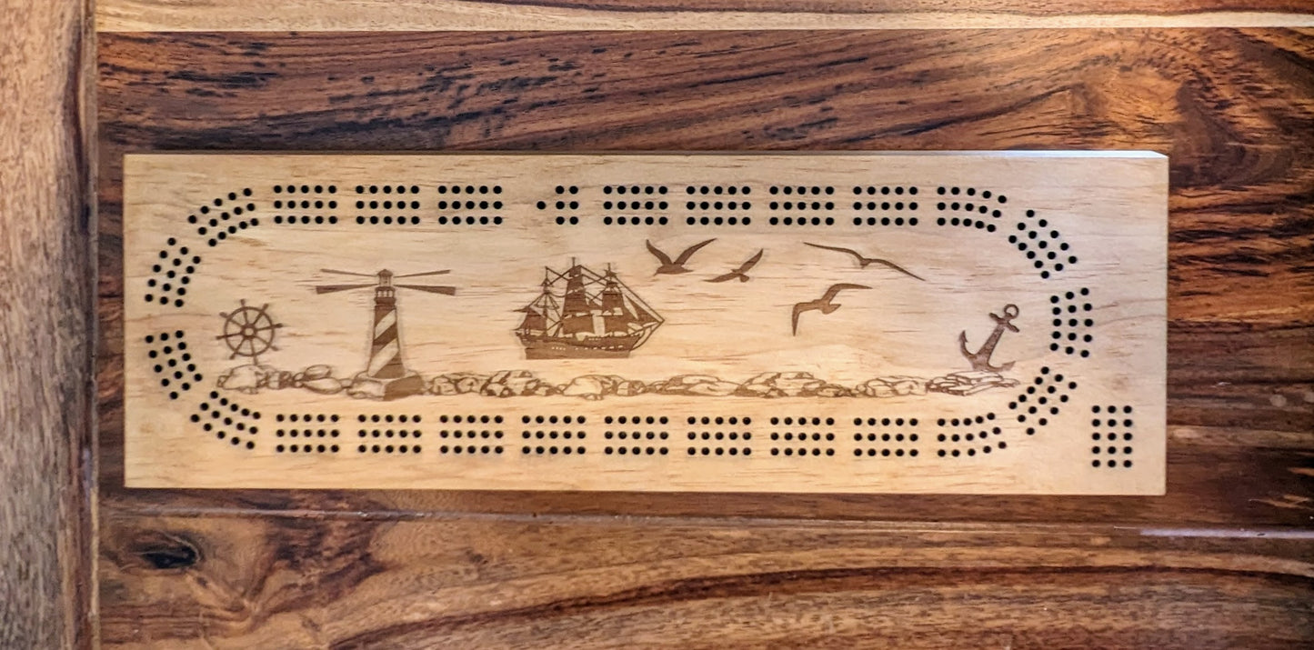 Nautical themed 3 Track Cribbage Board with a lighthouse and ship on the ocean