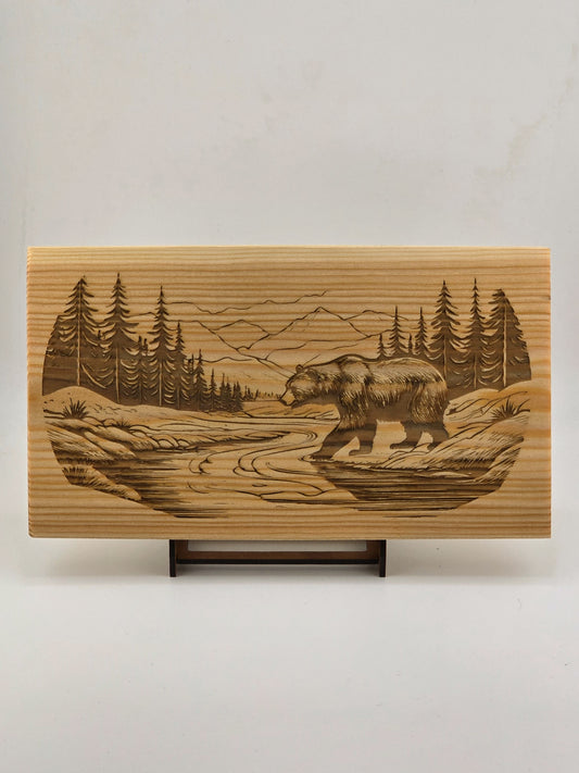 Bear walking through a river valley laser engraved nature art piece